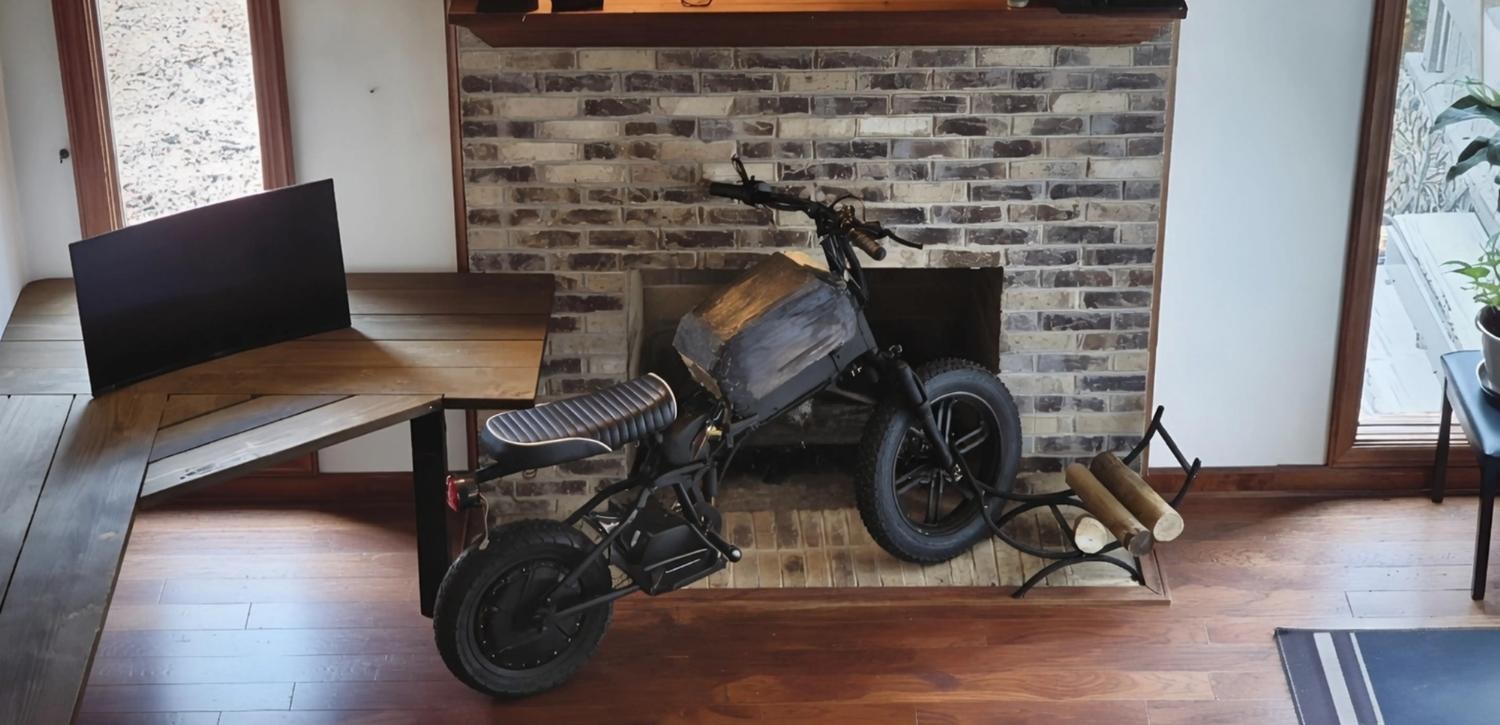 Design iteration one — early black prototype by the fireplace