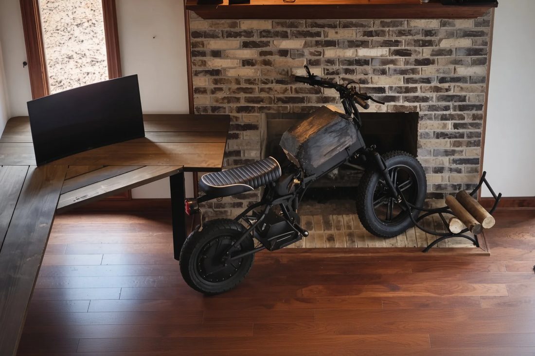Design iteration one — early black prototype by the fireplace