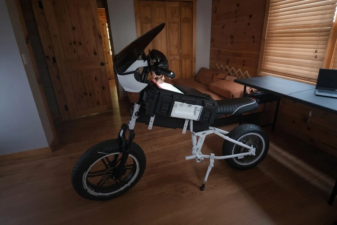 Design iteration two — white folding chassis with modular pack and windscreen